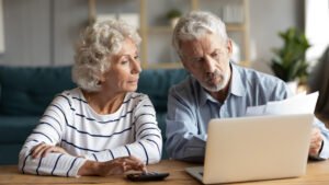 old couple are worried looking at the pension documents